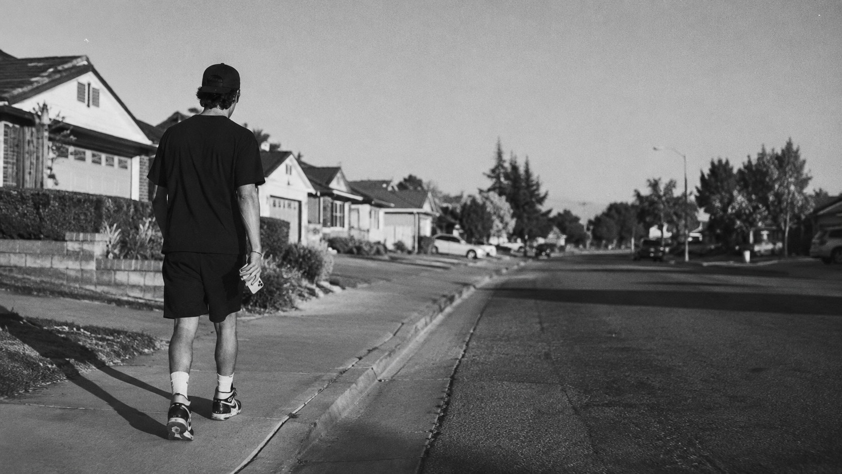 A NUERA representative walking a neighborhood route at golden hour